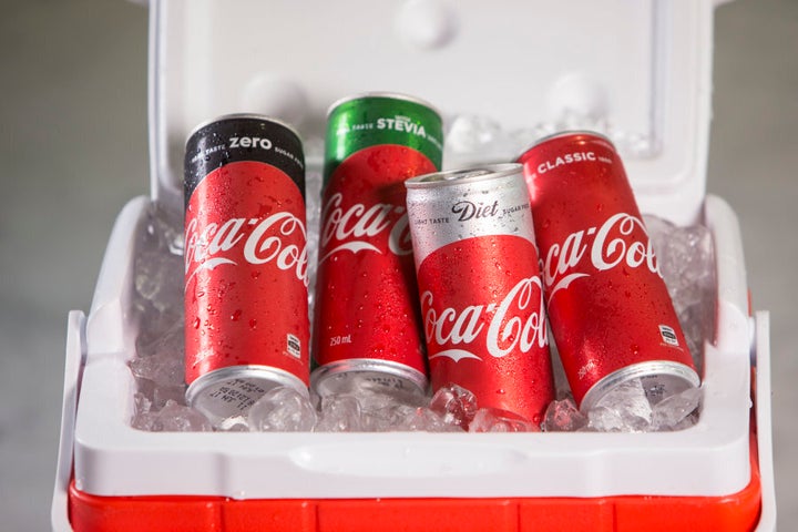 New-look Coke cans with a big, red disc.