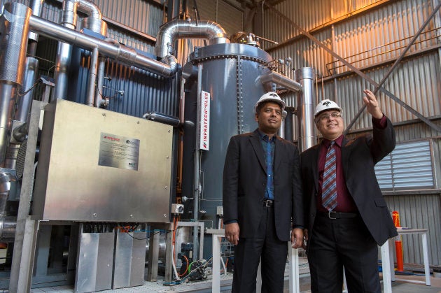 Entrepreneur Dr Rajesh Nullore with Professor Behdad Moghtaderi from the University of Newcastle inspecting the pilot Infratech CLES in Newcastle. The company is working on developing a machine small enough for the average family home.