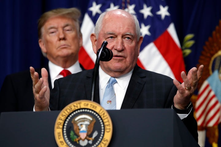 President Donald Trump listens to Agriculture Secretary Sonny Perdue speak in December. A group of USDA employees voted to un
