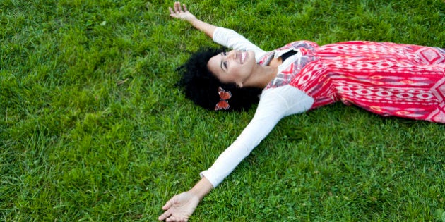 Young woman lying on grass