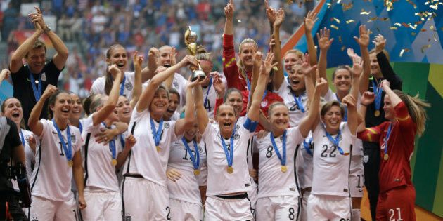 The United States Women's National Team celebrates with the trophy after they beat Japan 5-2 in the FIFA Women's World Cup soccer championship in Vancouver, British Columbia, Canada, Sunday, July 5, 2015. (AP Photo/Elaine Thompson)