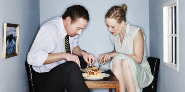 Couple eating dinner in small dining room