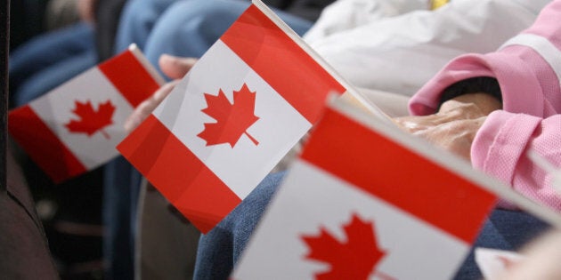 OTTAWA, ON - OCTOBER 25: Fans hold Canadian flags as they watch an NHL game between the Ottawa Senators and the New Jersey Devils at Canadian Tire Centre on October 25, 2014 in Ottawa, Ontario, Canada. (Photo by Jana Chytilova/Freestyle Photography/Getty Images)