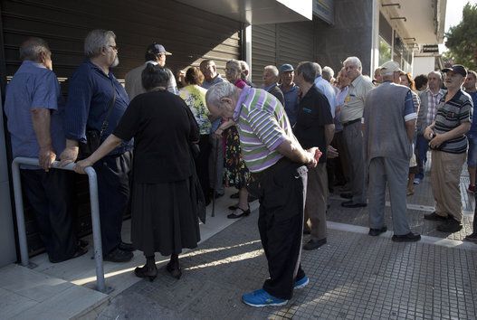Elderly people wait to withdraw cash in Greece