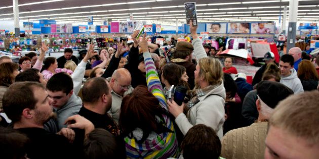 Shoppers vie for copies of video games at a Black Friday sale at a Wal-Mart Stores Inc. store in Mentor, Ohio, U.S., on Thursday, Nov. 24, 2011. Retailers are pouring on the discounts to attract consumers grappling with 9 percent unemployment and a slower U.S. economic expansion than previously estimated. Photographer: Daniel Acker/Bloomberg via Getty Images