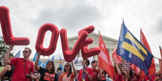IMAGE DISTRIBUTED FOR HUMAN RIGHTS CAMPAIGN - Marriage equality supporters rally on the steps of the Supreme Court as they wait for a decision Friday, June 26, 2015, in Washington. (Kevin Wolf/AP Images for Human Rights Campaign)