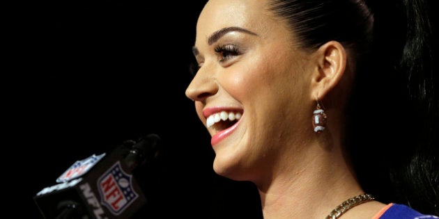 Katy Perry smiles at a halftime news conference for NFL Super Bowl XLIX football game Thursday, Jan. 29, 2015, in Phoenix. (AP Photo/David J. Phillip)