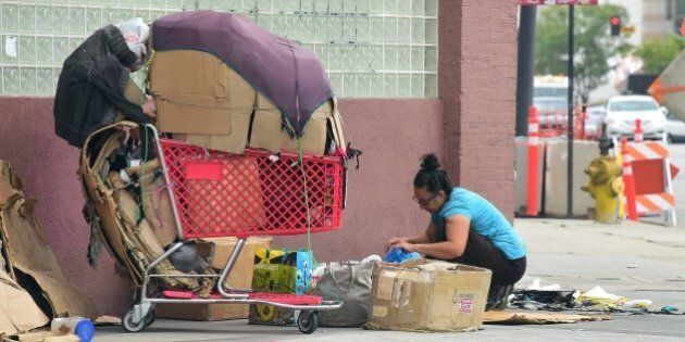 A homeless woman packs up her belongings after a night sleeping on the street in Los Angeles, California on May 12, 2015. A report released by the Los Angeles Homeless Authority on May 11 showed a 12% increase in the homeless population in both Los Angeles city and county, which according to the report have been driven by soaring rents, low wages and stubbornly high unemployment. One of the most striking findings from the biennial figures released saw the number of makeshift encampments, tents and vehicles occupied by the homeless increased 85%. AFP PHOTO / FREDERIC J. BROWN (Photo credit should read FREDERIC J. BROWN/AFP/Getty Images)
