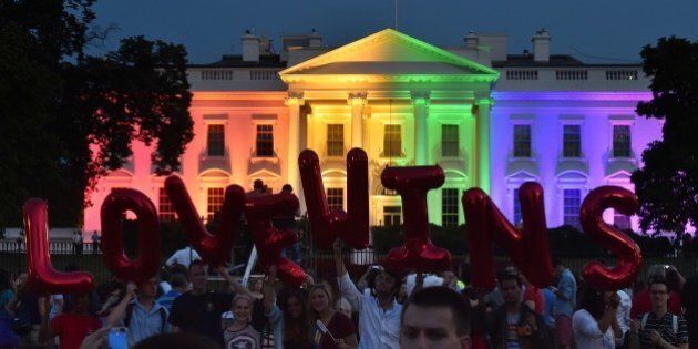 People hold balloon letters reading 'Love wins' in front of the White House lightened in the rainbow colors in Washington on June 26, 2015. The US Supreme Court ruled Friday that gay marriage is a nationwide right, a landmark decision in one of the most keenly awaited announcements in decades and sparking scenes of jubilation. AFP PHOTO/MLADEN ANTONOV (Photo credit should read MLADEN ANTONOV/AFP/Getty Images)