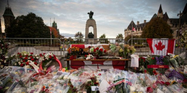 OTTAWA, ON - OCTOBER 23: Flowers and wreaths are left in memorial of Cpl. Nathan Cirillo of the Canadian Army Reserves, who was killed yesterday while standing guard in front of the National War Memorial by a lone gunman, on October 23, 2014 in Ottawa, Canada. After killing Cirillo the gunman stormed the main parliament building, terrorizing the public and politicians, before he was shot dead. (Photo by Andrew Burton/Getty Images)