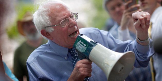 CONCORD, NH - MAY 27: Democratic presidential candidate and U.S. Sen. Bernie Sanders (I-VT) speaks to an overflow crowd through a megaphone after a campaign event at the New England College May 27, 2015 in Concord, New Hampshire. Sanders officially declared his candidacy yesterday and will run as a Democrat in the presidential election and is former Secretary of State Hillary ClintonÃs first challenger for the Democratic nomination. (Photo by Win McNamee/Getty Images)