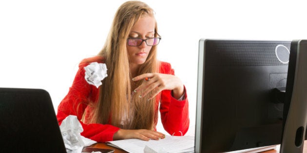 Businesswoman throwing a crumpled piece of paper