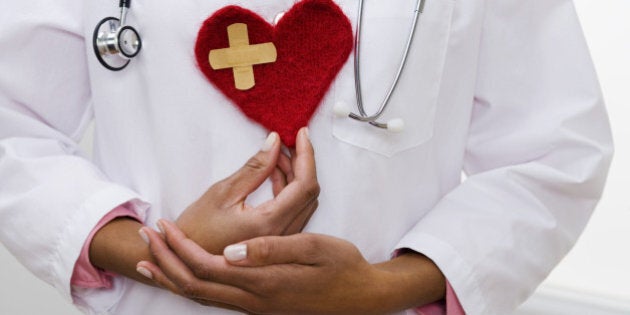 Doctor holding heart with bandage