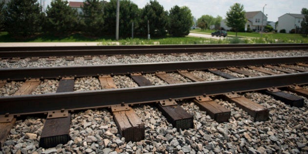 Train tracks utilized by freight trains for the transport of freight, including crude oil, stand across the street from a residential housing development in Plainfield, Illinois, U.S., on Friday, June 27, 2014. Last year's derailment in Quebec that killed 47 people and seven other major ones in the U.S. and Canada have spilled more than 3 million gallons of oil, with some cars catching fire or exploding. Photographer: Daniel Acker/Bloomberg via Getty Images