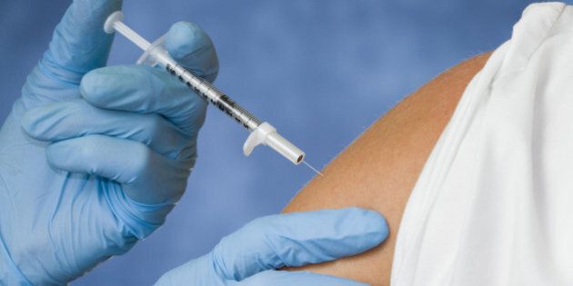 giving a flu shot from a needle.