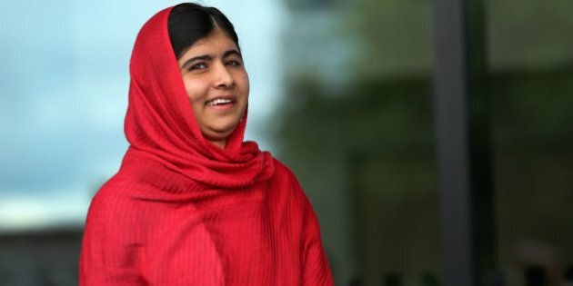 BIRMINGHAM, ENGLAND - SEPTEMBER 03: Malala Yousafzai opens the new Library of Birmingham at Centenary Square on September 3, 2013 in Birmingham, England. The new futuristic building was officially opened by 16-year-old Malala Yousafzai who was attacked by Taliban gunmen on her school bus near her former home in Pakistan in October 2012. The new building was designed by architect Francine Hoube and has cost 189 million GBP. The modern exterior of interlacing rings reflects the canals and tunnels of Birmingham. The library's ten floors will house the city's internationally significant collections of archives, photography and rare books as well as it's lending library. (Photo by Christopher Furlong/Getty Images)