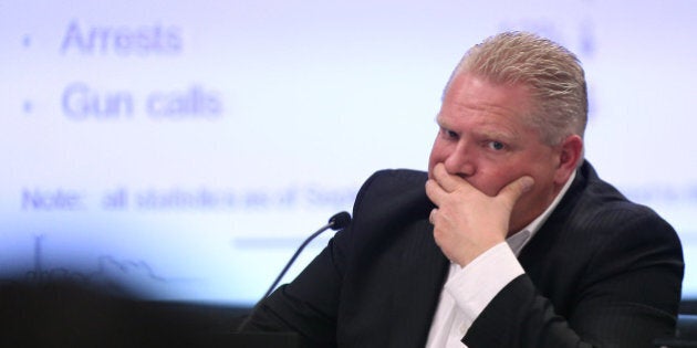 TORONTO, ON- DECEMBER 11 - Critic of the police chief, Councillor Doug Ford listens as Police Chief Bill Blair presents his 2014 budget to the Budget Committee at City Hall in Toronto. December 11, 2013. (Steve Russell/Toronto Star via Getty Images)