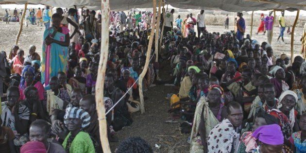 IDP's (Internally displaced persons) wait to receive food rations at the UNMISS Protection of Civilian (POC) site in Bentiu, Unity State, on February 27, 2015. The camp receives up to 200 new IDP each day, due to lack of services in the town. The World Health Organization today appealed for 1.0 billion USD in additional funds to help provide life-saving health services to millions in need in conflict-ravaged Syria, Iraq, Central African Republic and South Sudan. For South Sudan, which has been wracked by fighting since an alleged attempted coup in December 2013, 90 million USD is needed to provide vital health services to some 3.35 million people, WHO said. AFP PHOTO / CHARLES LOMODONG (Photo credit should read CHARLES LOMODONG/AFP/Getty Images)