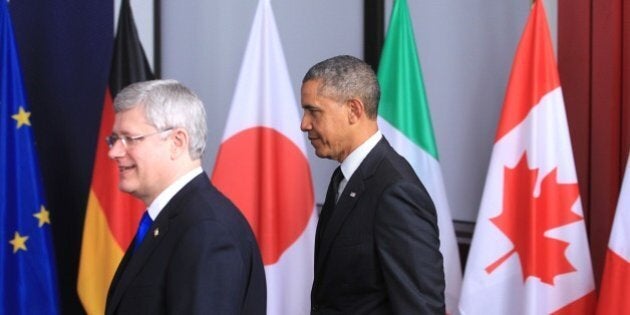 U.S. President Barack Obama, right, and Canadian Prime Minister Stephen Harper walk together to a group photo of heads of state at a G7 summit in Brussels on Thursday, June 5, 2014. The leaders of the G-7 group of major economies center their effort during the concluding day of their summit on spurring growth and jobs in an attempt to reinforce a rebound from the global financial crisis. (AP Photo/Yves Logghe)