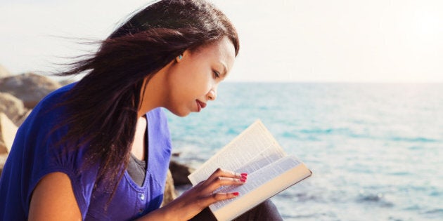 beautiful girl reading her...