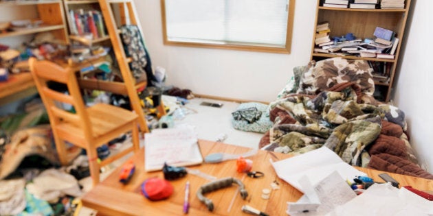 Teenage boy's messy room. Tilt shift lens, with focus on pillow & comforter