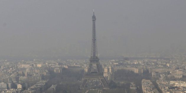 FILE - In this March 14, 2014 file photo, the Eiffel Tower, is photographed through the smog in Paris. Paris police have lowered speed limits and ordered a halt to trash burning Wednesday, March 18, 2015 as part of emergency measures triggered by a spike in air pollution â months before the city hosts a major international climate conference. (AP Photo/Jacques Brinon, File)