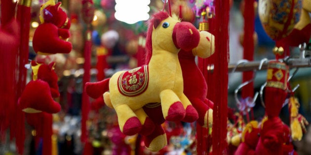 Horse figures are put on display at a street market stall selling Chinese New Year items in Hong Kong on January 3, 2014. The Chinese New Year of the horse falls on January 31. AFP PHOTO / ALEX OGLE (Photo credit should read Alex Ogle/AFP/Getty Images)