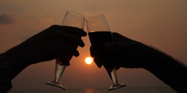 A couple drinking at the beach