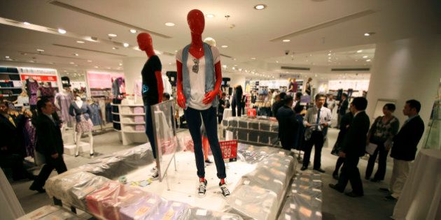 Guests look around interior of the largest global flagship store of Uniqlo during its pre-opening Thursday, May 13, 2010 in Shanghai, China. The UNIQLO Shanghai Global Flagship Store will open on May 15 officially. (AP Photo/Eugene Hoshiko)