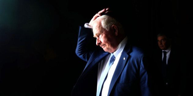 Canadian Governor General of Canada David Johnston adjusts his kippa on November 2, 2016 during a visit to the Yad Vashem Holocaust Memorial museum in Jerusalem commemorating the six million Jews killed by the Nazis during World War II. AFP PHOTO/GALI TIBBON / AFP / GALI TIBBON (Photo credit should read GALI TIBBON/AFP/Getty Images)