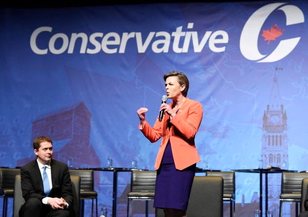 Kellie Leitch speaks as Andrew Scheer listens during the Conservative Party of Canada leadership debate in Toronto on April 26, 2017.