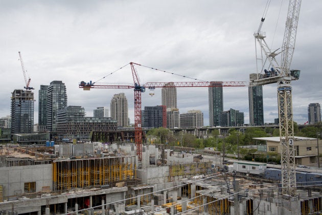 A crane operates at the Minto Westside condominium under construction in Toronto on May 26, 2017.