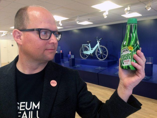 In this photo taken on Thursday, June 1, 2017, Samuel West, curator of the Museum of Failure, holds a bottle of Heinz Green Sauce tomato ketchup at the Museum of Failure in Helsingborg, Sweden. (AP Photo/James Brooks)