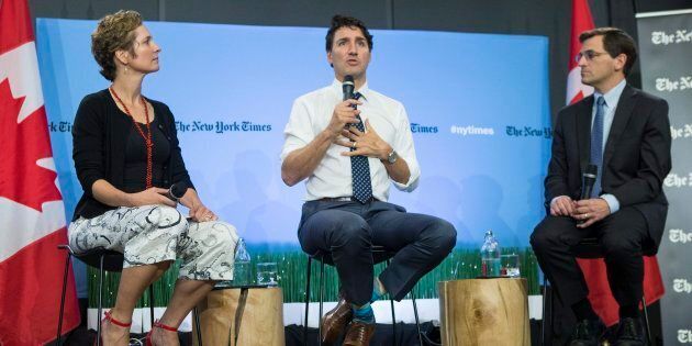 Prime Minister Justin Trudeau sits alongside Peter Baker, Chief White House Correspondent of the New York Times, and Catherine Porter, Toronto Bureau Chief for The New York Times, during a panel discussion in Toronto on June 22, 2017.