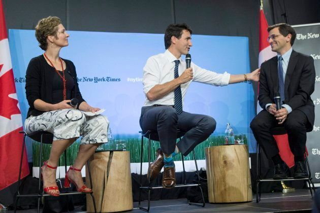 Prime Minister Justin Trudeau, centre, sits alongside Peter Baker, chief White House correspondent of the New York Times, right, and Catherine Porter, Toronto bureau chief for The New York Times, during a panel discussion in Toronto on June 22, 2017.