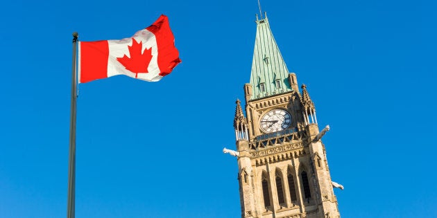 A Canadian flag is shown outside of Parliament in Ottawa.