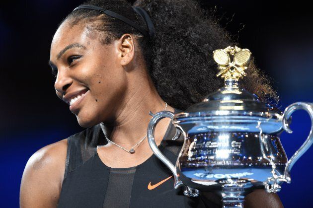 Serena Williams of the US holds up the trophy following her victory over Venus Williams of the US in the women's singles final on day 13 of the Australian Open tennis tournament in Melbourne on January 28, 2017. (PAUL CROCK/AFP/Getty Images)