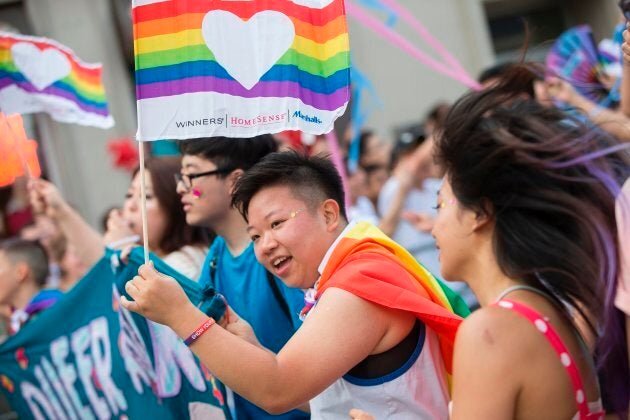 A woman waves a pride flag as she marches in the Pride Parade in Toronto, Ontario, June 25, 2017.