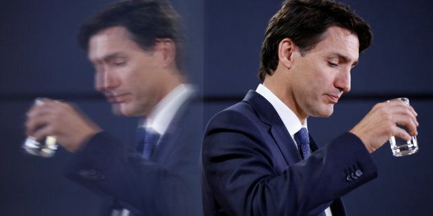 Prime Minister Justin Trudeau drinks water during a news conference in Ottawa on June 27, 2017.
