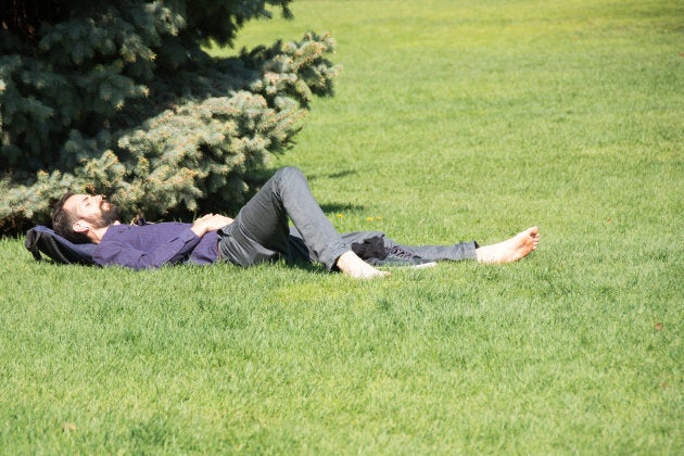 A man sneaks a nap under the spring sun in Toronto's Queen's Park.