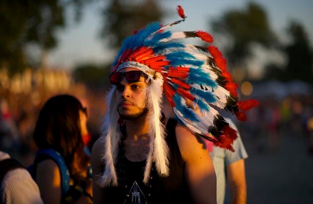 A festival-goer wears a Native American headdress during the Governors Ball Music Festival on Randall's Island in New York, NY on June 7, 2014.