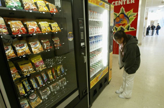 A student buys snacks from a vending machine at Mission High School April 8, 2004 in San Francisco, California.