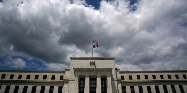 Flags fly over the Federal Reserve Headquarters on a windy day in Washington, U.S., May 26, 2017.