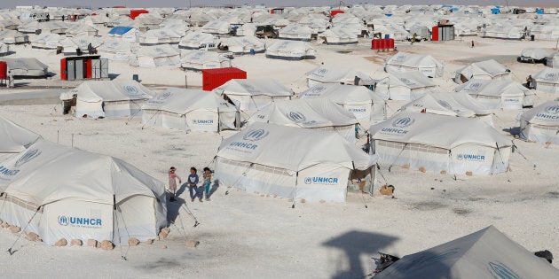 Children walk at a camp for people displaced from fighting in the Islamic State stronghold of Raqqa, in Ain Issa, Syria June 14, 2017.