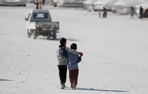 Two boys walk at a camp for people displaced from fighting in the Islamic State stronghold of Raqqa, in Ain Issa, Syria June 14, 2017.