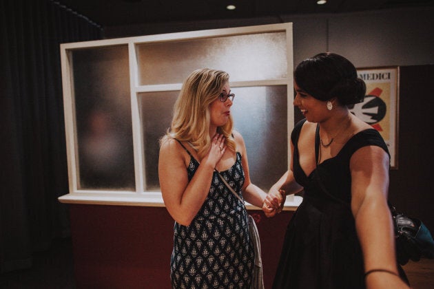 Kirsten, the maid of honour, showing the couple's friend Alyssa the sign that announced the wedding.