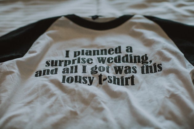 The matching T-shirts the couple gave their wedding party at the rehearsal dinner, which was a hotel pizza party.