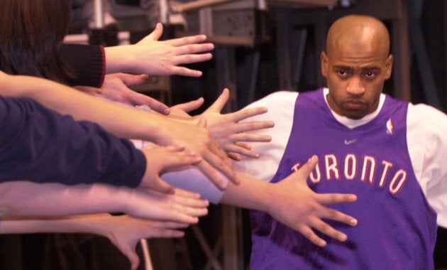 Toronto Raptors' Vince Carter heads to the court in the ACC and is greeted by outstretched hands of fans during the 5th annual Bell Raptorball Open Practice. Carter and teammates worked out in front of several thousand fans today. (RICK MADONIK/TORONTO STAR) (Photo by Rick Madonik/Toronto Star via Getty Images)