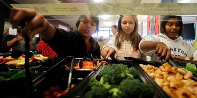 Students get their lunch from a salad bar at the school cafeteria in San Diego, California.