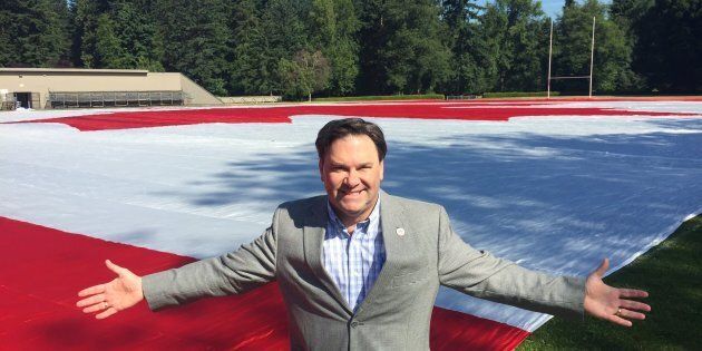 Vancouver area MP Don Davies with a huge Canadian flag made by one of his constituents. The flag is on display in Stanley Park on Canada Day.